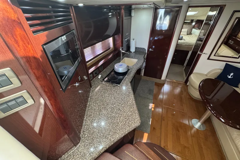 Slide: The Image of Luxurious interior of 2008 Sea Ray 40 Sundancer yacht with modern kitchen and seating area. - 33