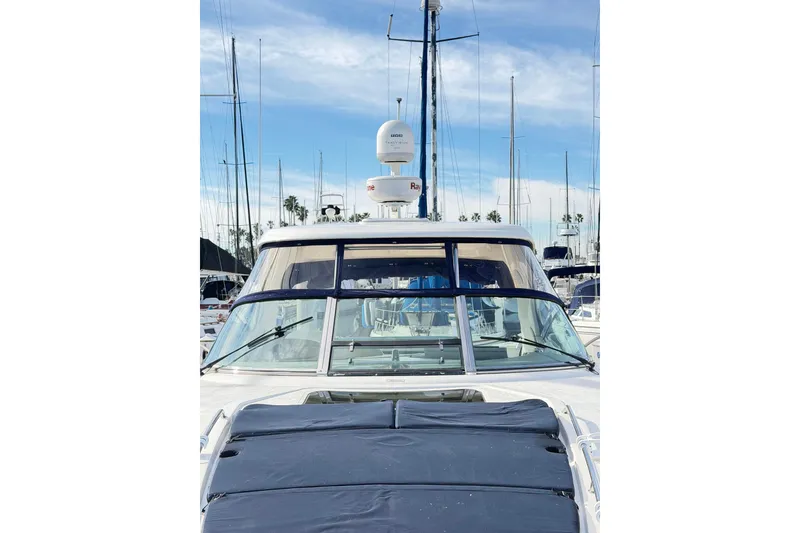 Slide: The Image of 2008 Sea Ray 40 Sundancer yacht docked in marina, clear sky background. - 4