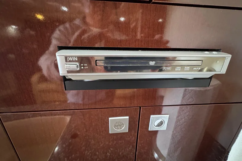 Slide: The Image of DVD player in 2008 Sea Ray 40 Sundancer yacht with wooden cabinet background. - 42