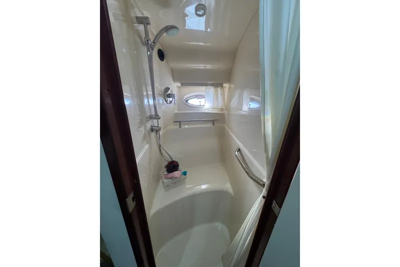 Slide: The Image of Shower area in 2008 Sea Ray 40 Sundancer yacht, featuring modern fixtures and porthole window. - 48