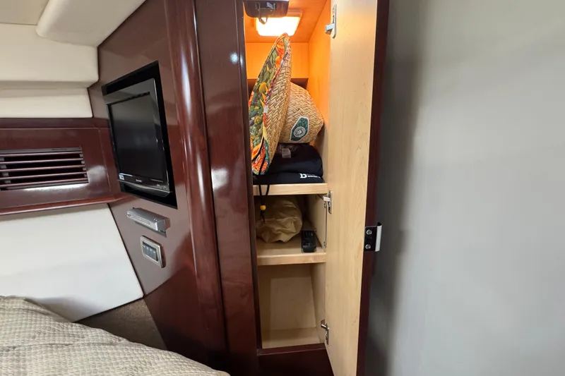 Slide: The Image of Cabin interior of 2008 Sea Ray 40 Sundancer with open closet and TV. - 55