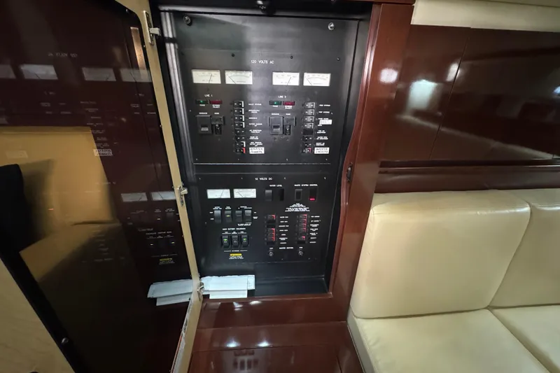 Slide: The Image of Electrical panel inside 2008 Sea Ray 40 Sundancer yacht, featuring switches and gauges. - 59