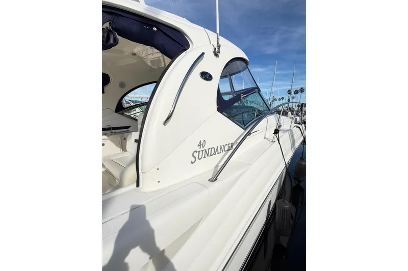 Slide: The Image of 2008 Sea Ray 40 Sundancer yacht docked under clear blue sky. - 6