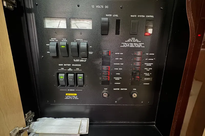 Slide: The Image of Electrical control panel of a 2008 Sea Ray 40 Sundancer boat, featuring switches and gauges. - 60