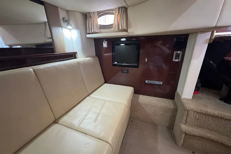 Slide: The Image of Interior of 2008 Sea Ray 40 Sundancer with beige seating and wall-mounted TV. - 63