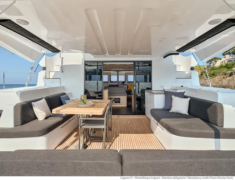 Slide: The Image of Luxurious Lagoon 51 ICONIC 2025 yacht interior with elegant seating and dining area. - 27