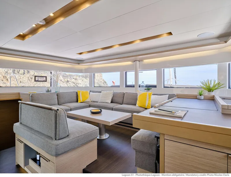Slide: The Image of Luxurious interior of 2025 Lagoon 51 ICONIC yacht with modern seating and panoramic windows. - 38
