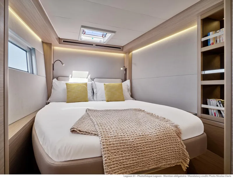 Slide: The Image of Luxurious bedroom interior of 2025 Lagoon 51 ICONIC yacht with modern design and cozy bedding. - 41