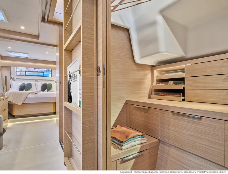 Slide: The Image of Luxurious interior of 2025 Lagoon 51 ICONIC yacht, featuring modern bedroom and storage space. - 49