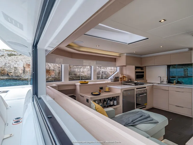 Slide: The Image of Modern interior of 2025 Lagoon 55 yacht with sleek kitchen and panoramic windows. - 17