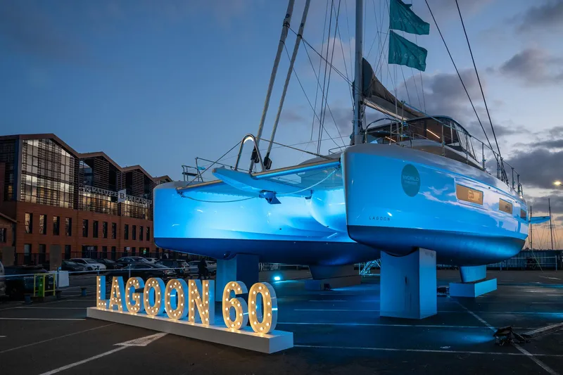 Slide: The Image of 2025 Lagoon 60 yacht illuminated at dusk, showcasing sleek design and modern architecture. - 10