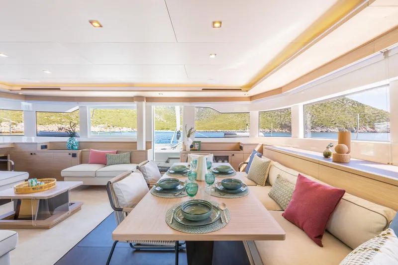 Slide: The Image of Luxurious interior of 2025 Lagoon 60 yacht with elegant dining setup and scenic views. - 23