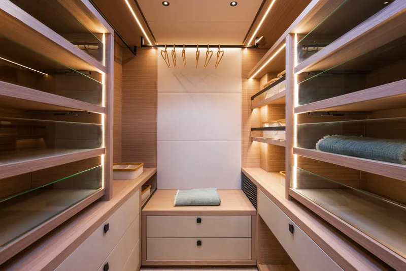 Slide: The Image of Luxurious walk-in closet on Lagoon Eighty 2 yacht, featuring wooden shelves and modern lighting, 2025 model. - 29