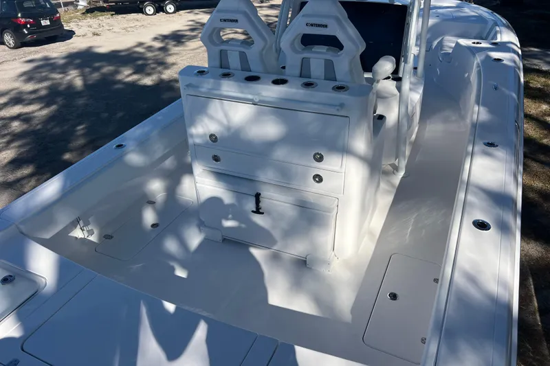 Slide: The Image of 2026 Contender 29 Bay boat cockpit with steering wheel and control panel. - 10