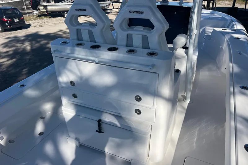 Slide: The Image of 2026 Contender 29 Bay boat dashboard with dual screens and steering wheel. - 11
