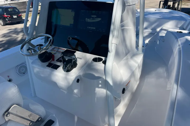 Slide: The Image of 2026 Contender 29 Bay boat interior with cushioned seating and cup holders. - 13