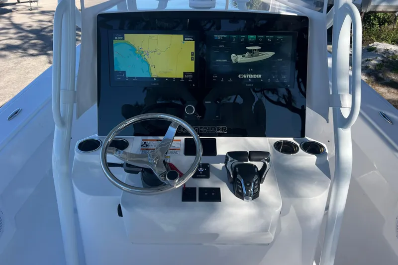 Slide: The Image of 2026 Contender 29 Bay boat interior with cushioned seating and rod holders. - 14