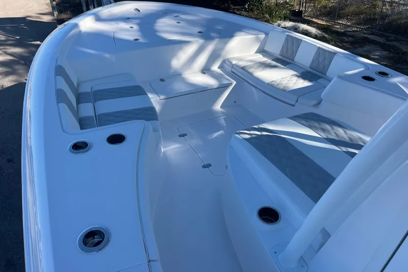 Slide: The Image of 2026 Contender 29 Bay boat interior with cushioned seating and cup holders. - 16