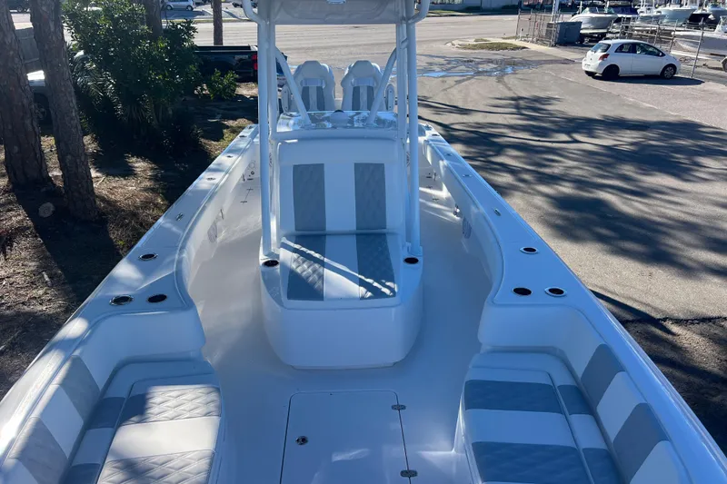 Slide: The Image of 2026 Contender 29 Bay boat interior with dual white seats and steering wheel. - 18