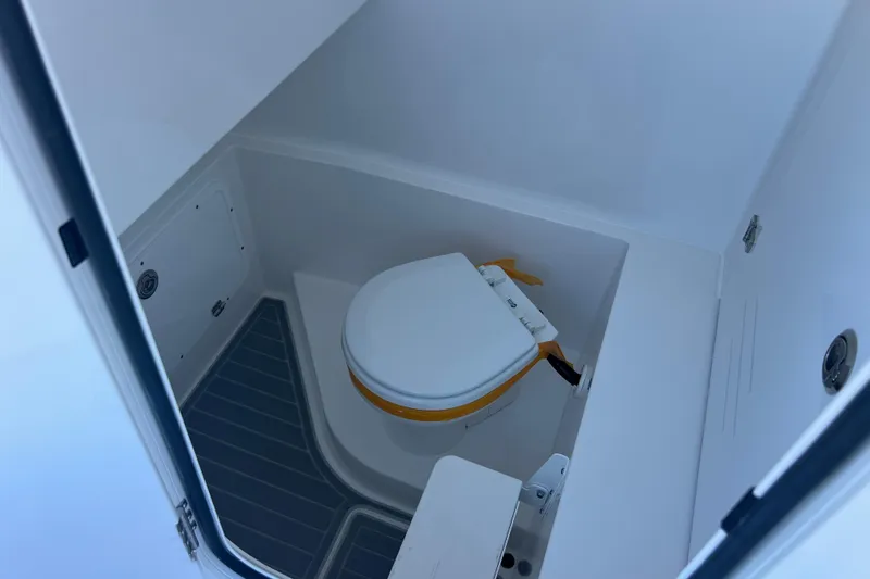 Slide: The Image of 2026 Contender 29 Bay boat interior with storage compartments and dual engines. - 20