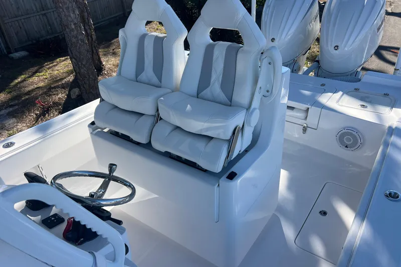 Slide: The Image of 2026 Contender 29 Bay boat seating area with storage compartments and speakers. - 21
