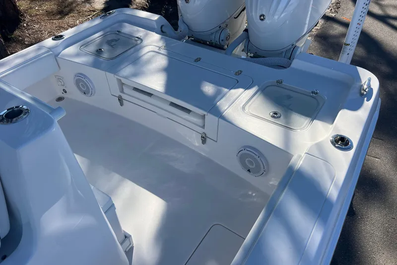 Slide: The Image of 2026 Contender 29 Bay boat deck with storage compartments and speakers. - 23