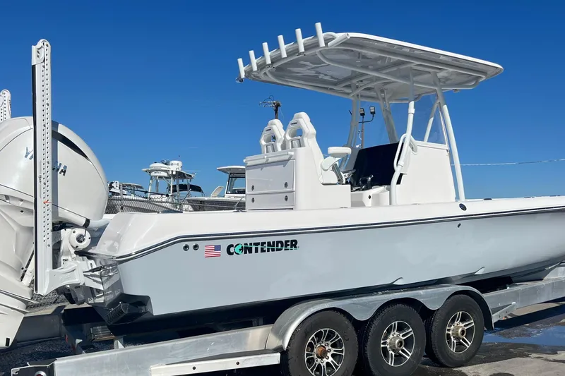 Slide: The Image of 2026 Contender 29 Bay boat with American flag and logo on the side. - 6