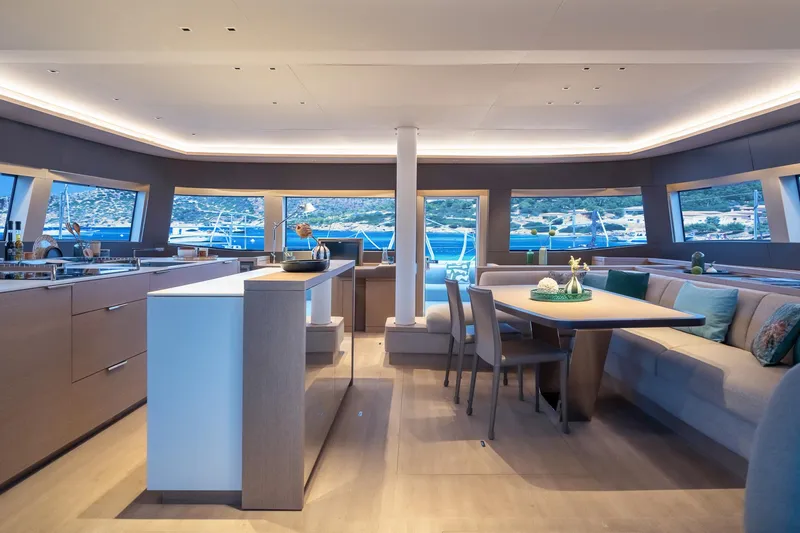 Slide: The Image of Luxurious interior of 2025 Lagoon SIXTY 5 yacht with modern dining area and panoramic windows. - 10