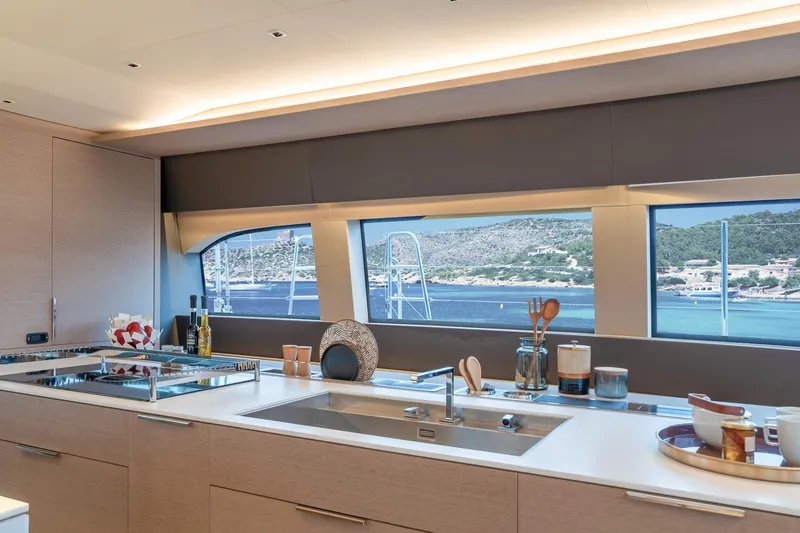 Slide: The Image of Modern kitchen interior on 2025 Lagoon SIXTY 5 yacht with ocean view. - 16