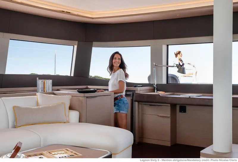 Slide: The Image of Woman in Lagoon SIXTY 5 yacht interior, 2025 model, enjoying luxurious modern design. - 17
