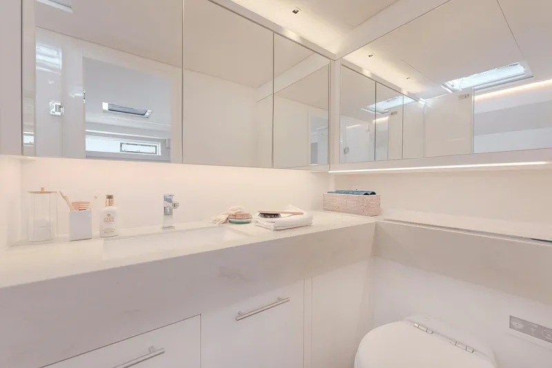 Slide: The Image of Modern bathroom interior in 2025 Lagoon SIXTY 5 yacht, featuring sleek white design and ample storage. - 33