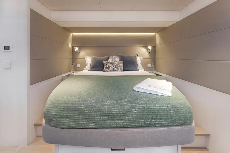 Slide: The Image of Luxurious bedroom interior of 2025 Lagoon SIXTY 5 yacht with modern design and cozy bedding. - 35