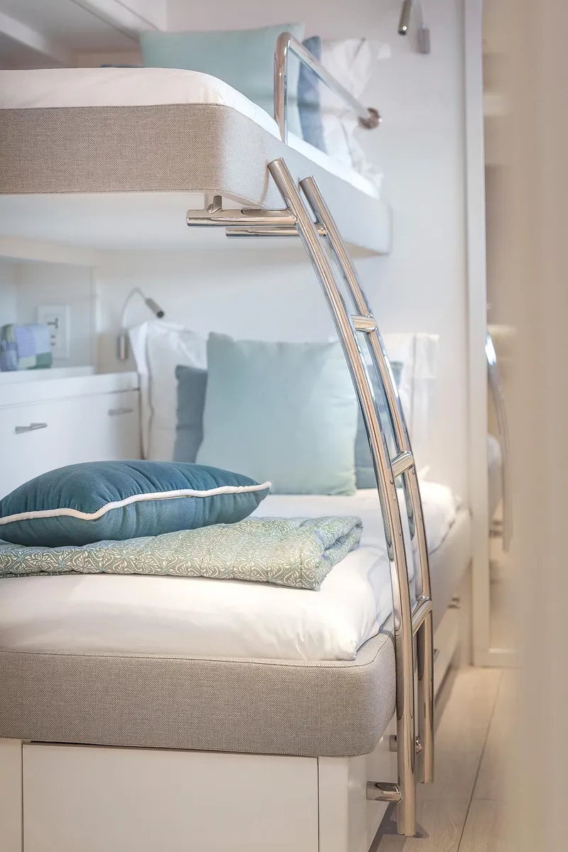 Slide: The Image of 2025 Lagoon SIXTY 5 yacht interior with modern bunk beds and elegant decor. - 40