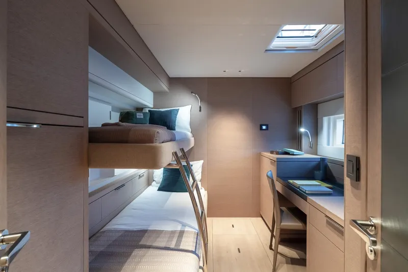 Slide: The Image of Luxurious cabin interior of 2025 Lagoon SIXTY 5 yacht with bunk beds and desk. - 42