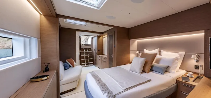 Slide: The Image of Luxurious bedroom interior of 2025 Lagoon SIXTY 7 yacht, featuring elegant design and cozy ambiance. - 16