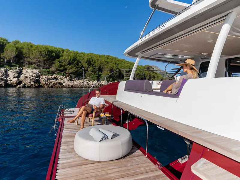 Slide: The Image of Luxury Lagoon SIXTY 7 yacht, 2025 model, with people relaxing on deck by the sea. - 6