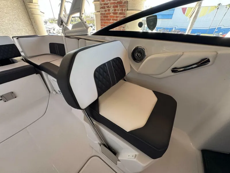 Slide: The Image of 2024 Monterey M-65 boat interior with black and white seating and speaker. - 10