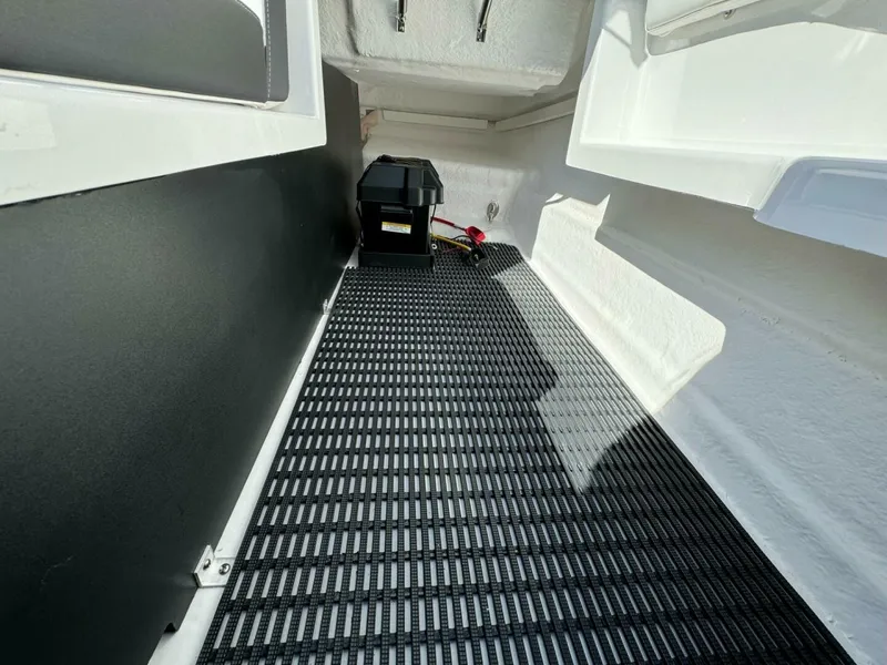 Slide: The Image of 2024 Monterey M-65 boat interior with battery compartment and non-slip flooring. - 20