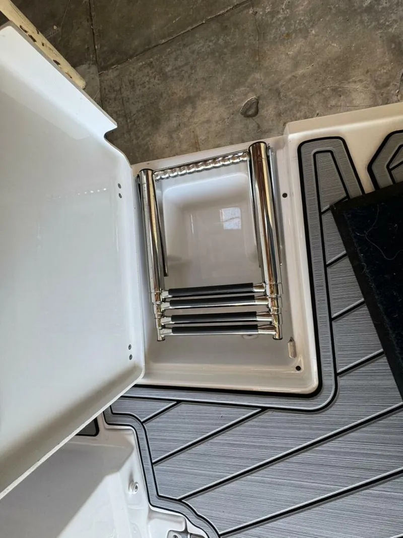 Slide: The Image of 2024 Monterey M-65 boat ladder compartment with stainless steel retractable ladder. - 4