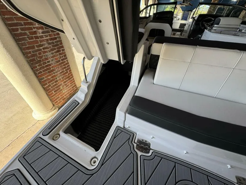 Slide: The Image of 2024 Monterey M-65 boat interior with white seating and sleek design elements. - 5