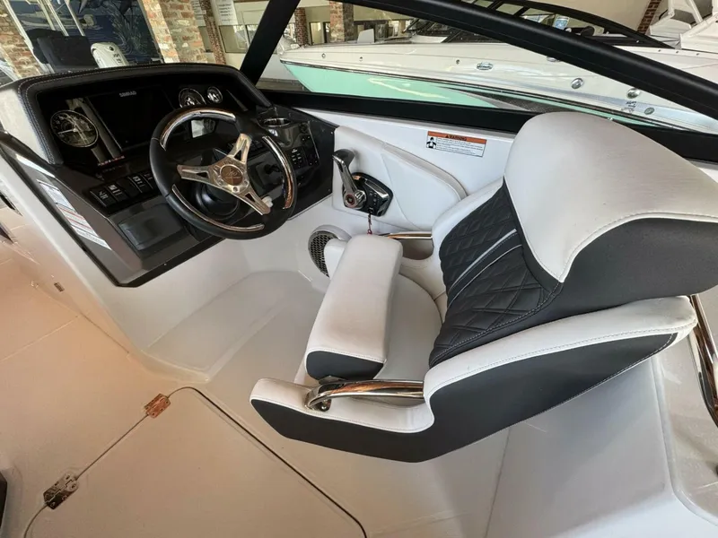 Slide: The Image of 2024 Monterey M-65 boat interior with steering wheel and cushioned seating. - 9