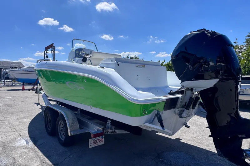 Slide: The Image of 2006 Baja 250 Sportfish boat with green hull on trailer, sunny day. - 5