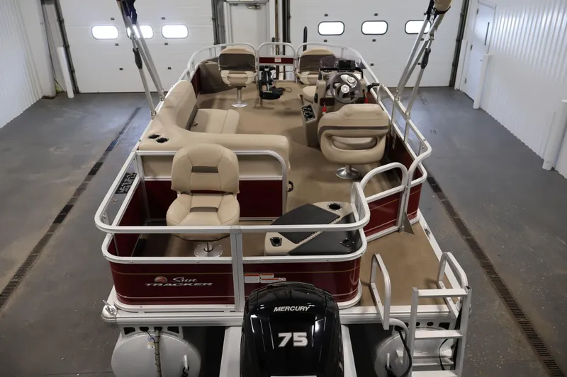 Slide: The Image of 2021 Sun Tracker Bass Buggy 18 DLX pontoon boat with Mercury 75 engine in a garage. - 10