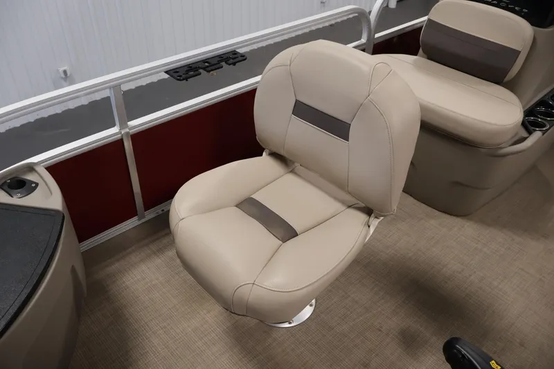 Slide: The Image of 2021 Sun Tracker Bass Buggy 18 DLX interior with beige seating and carpeted flooring. - 18