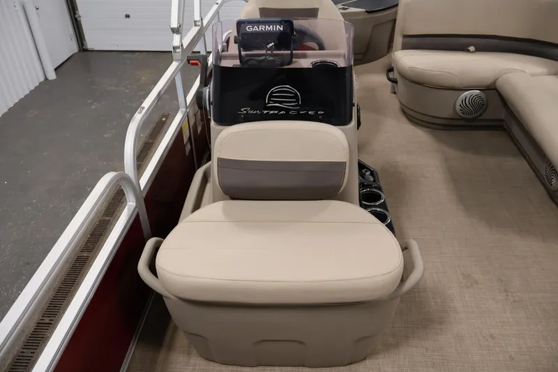 Slide: The Image of 2021 Sun Tracker Bass Buggy 18 DLX interior with beige seating and Garmin equipment. - 21