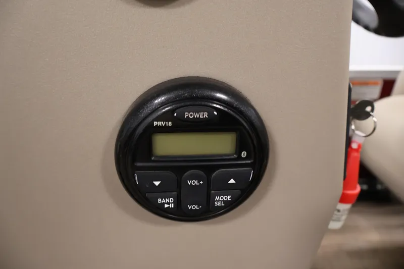 Slide: The Image of Control panel on 2021 Sun Tracker Bass Buggy 18 DLX boat, featuring power and volume buttons. - 27