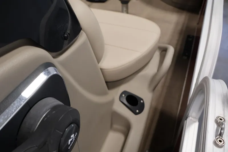 Slide: The Image of 2021 Sun Tracker Bass Buggy 18 DLX interior with beige seating and steering details. - 31