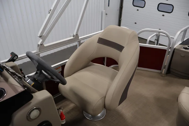 Slide: The Image of 2021 Sun Tracker Bass Buggy 18 DLX boat interior with captain's chair and steering wheel. - 32