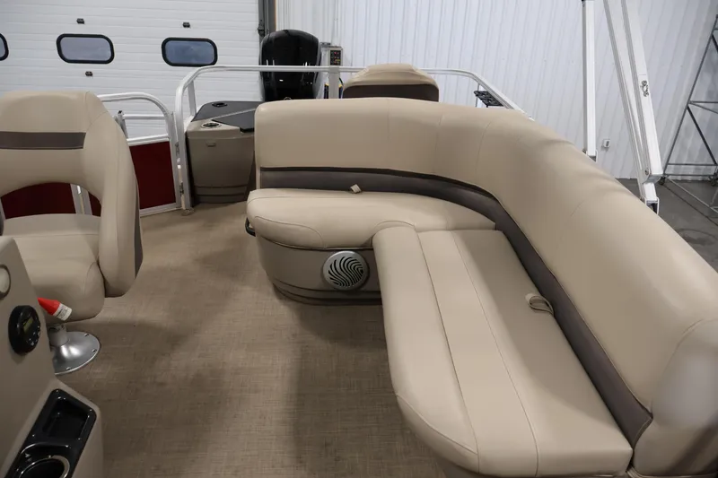 Slide: The Image of 2021 Sun Tracker Bass Buggy 18 DLX interior with beige seating and steering console. - 33