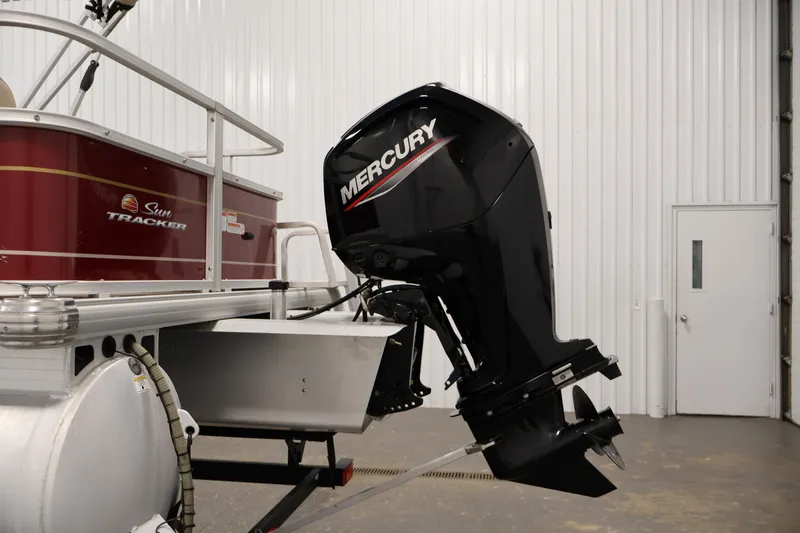 Slide: The Image of 2021 Sun Tracker Bass Buggy 18 DLX with Mercury outboard motor in a garage. - 42